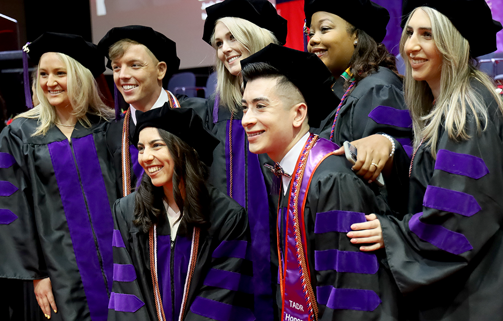 Students posing for a photo at UIC Law Commencement