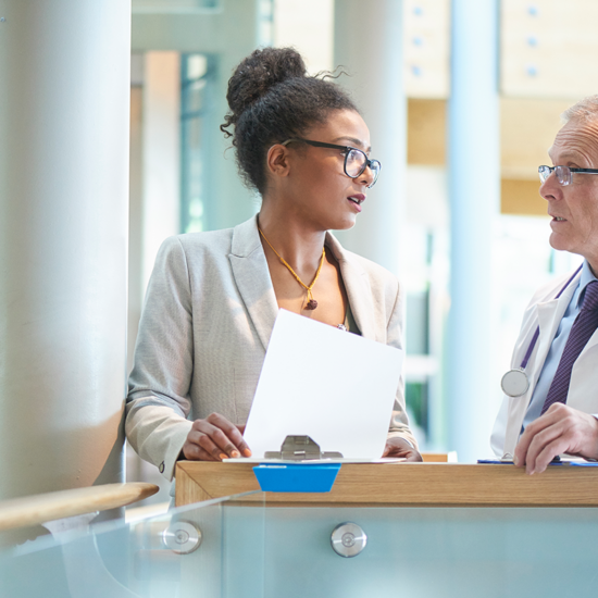 Adminstrator Woman and Medical Professional Discussing Policy