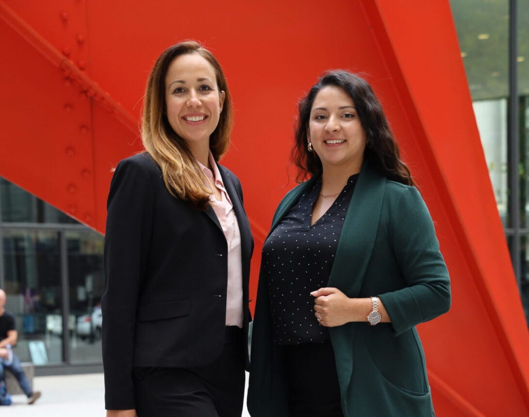 IHRC Director Sarah Davila A and Staff Attorney Alejandra Palacios pose together in front of chicago monument