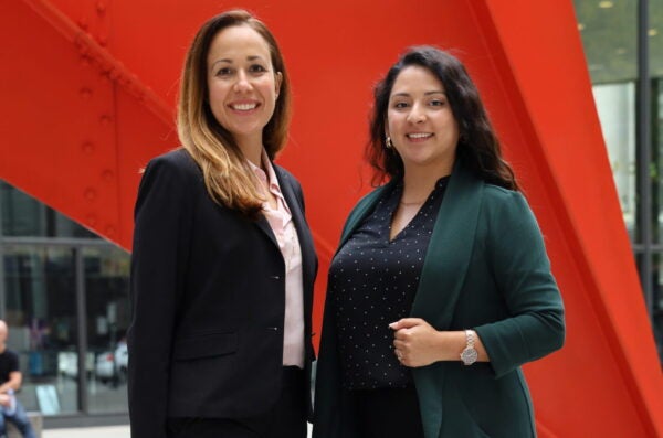 IHRC Director Sarah Davila A and Staff Attorney Alejandra Palacios pose together in front of chicago monument